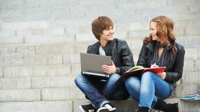 Two smiling young students outdoors