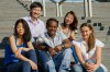 Multiethnic group of university students sitting on steps