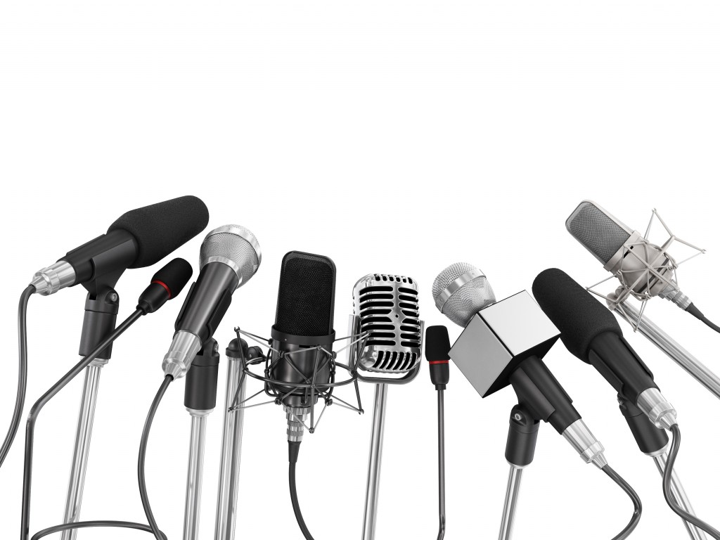 Various microphones aligned at press conference isolated over a