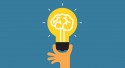 Hand holding light bulb. Concept of the success idea.