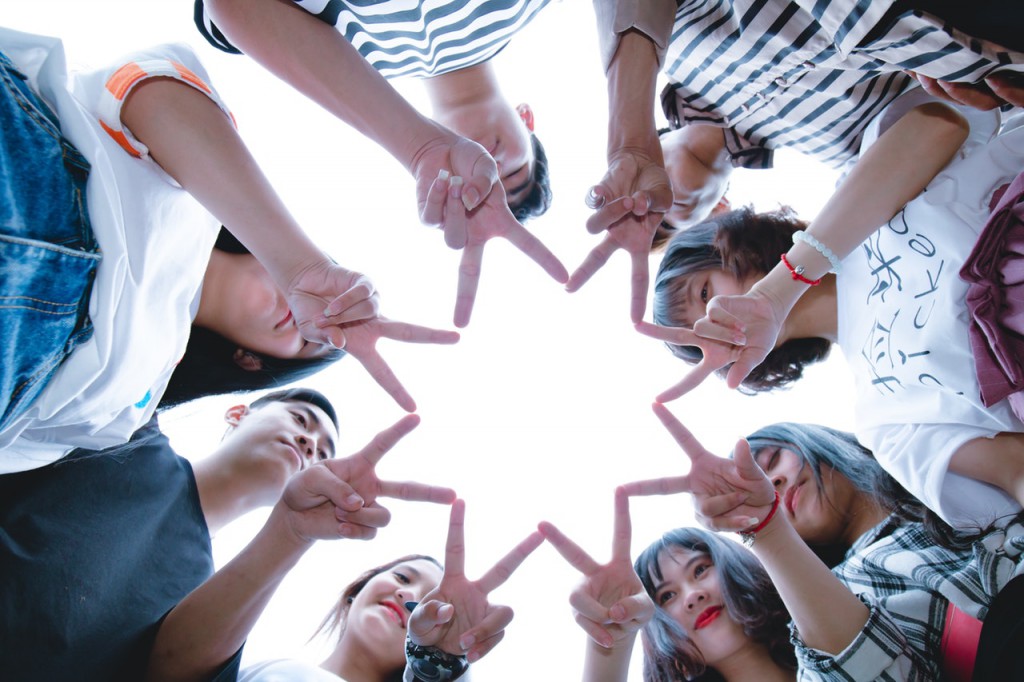 group-of-people-forming-star-using-their-hands-1116302