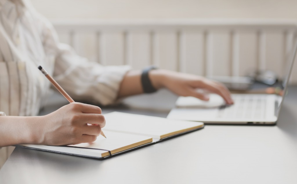 photo-of-person-writing-on-notebook-3758898