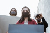 Portrait students holding blank paper conducting demonstrations