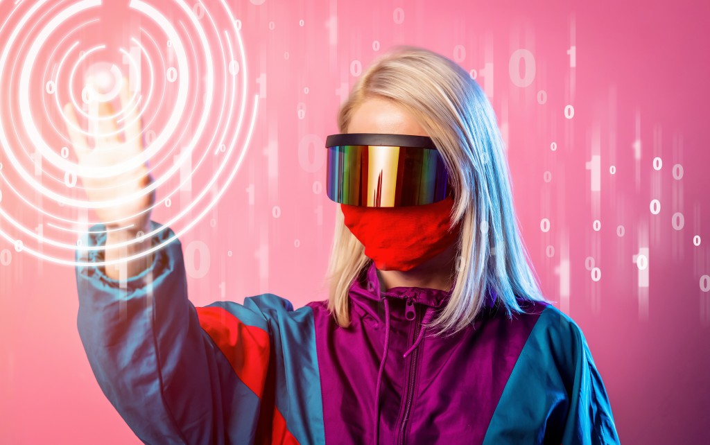 Woman in a face mask and 3D glasses on pink background