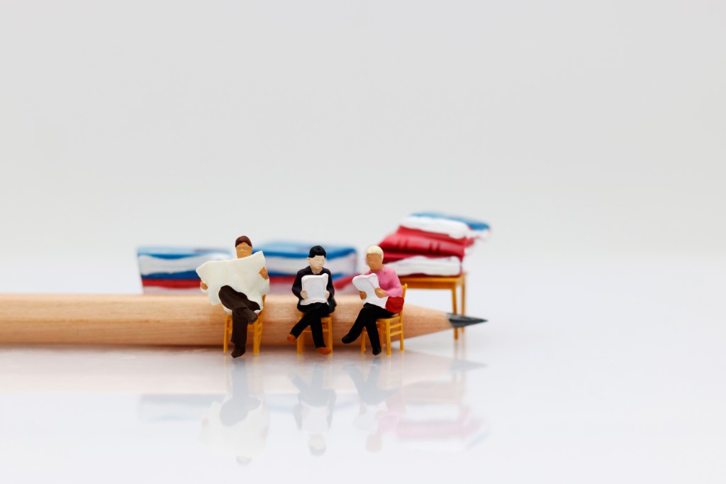 Miniature people reading  book with pencil, education or business concept.