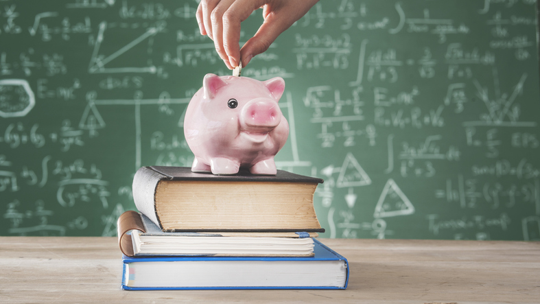 Female putting coin into piggy bank