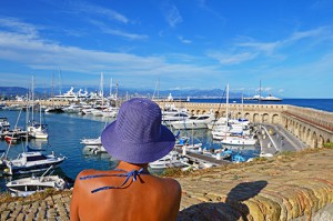 Young woman in violet beach hat