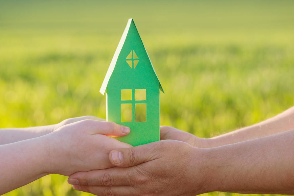 stock-photo-paper-house-in-hand-outdoor