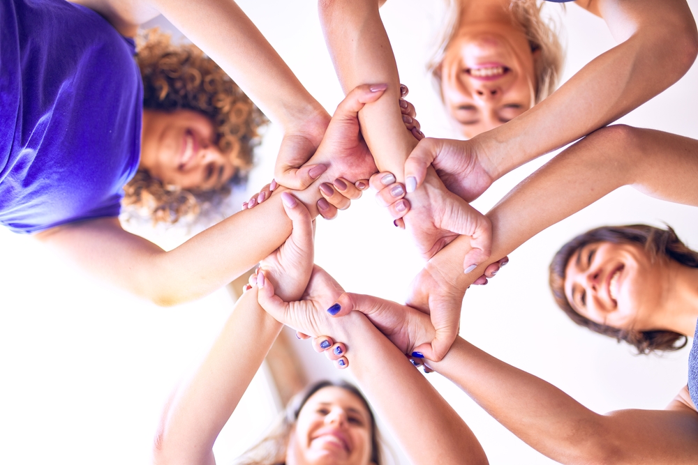 Young beautiful sportwomen doing gesture with hands