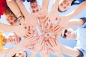 many hands over blue sky background