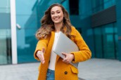 businesswoman-extend-hand-ready-handshake-greeting-client-business-partner-sign-deal-woman-hr-meeting-employee-interview-nice-meet-you-business-person-with-laptop-yellow-coat-standing-outdoors_91014-4556