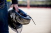 Closeup shot of a male holding his motorcycle helmet with a blurred background